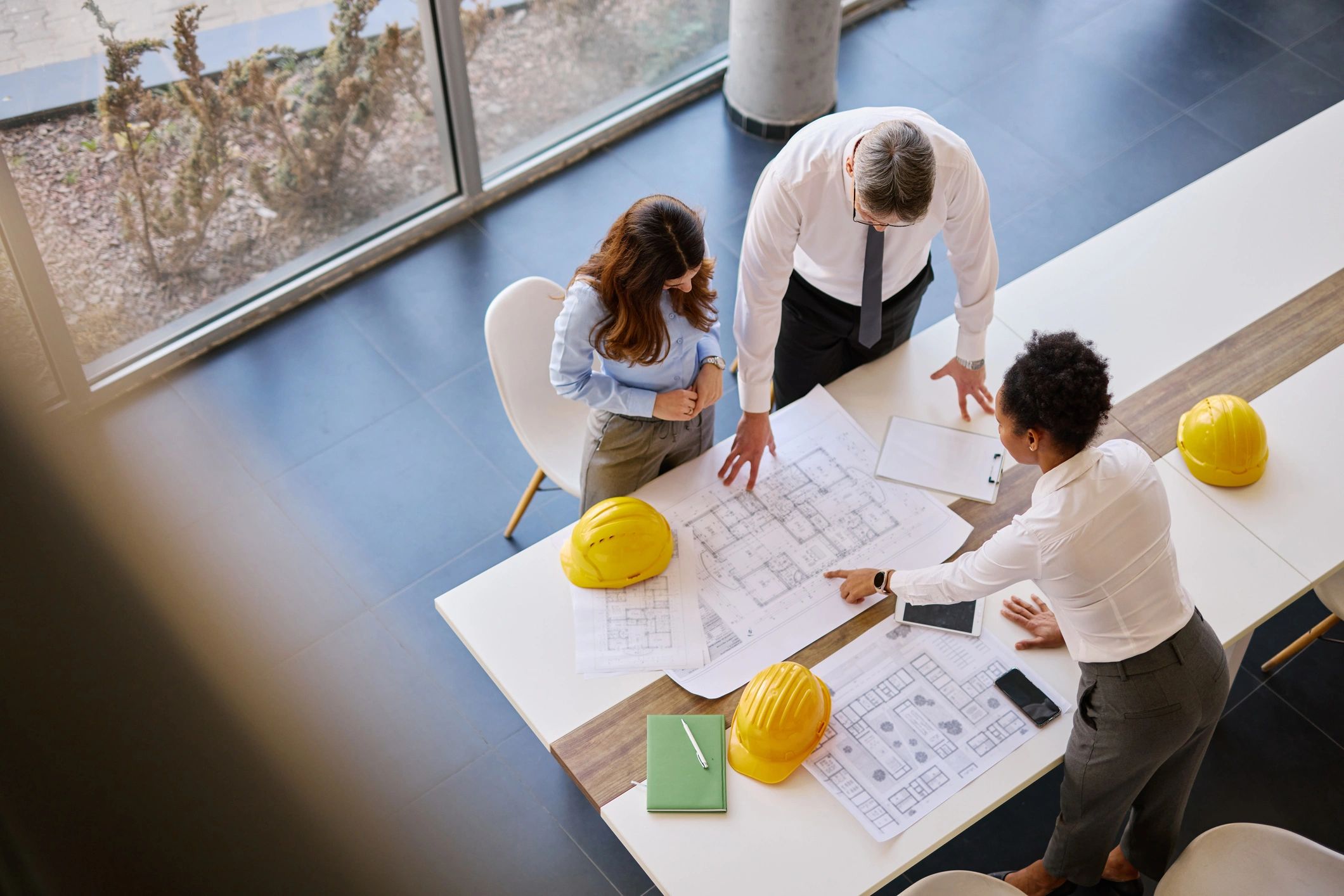 Architects analyzing blueprints in the office