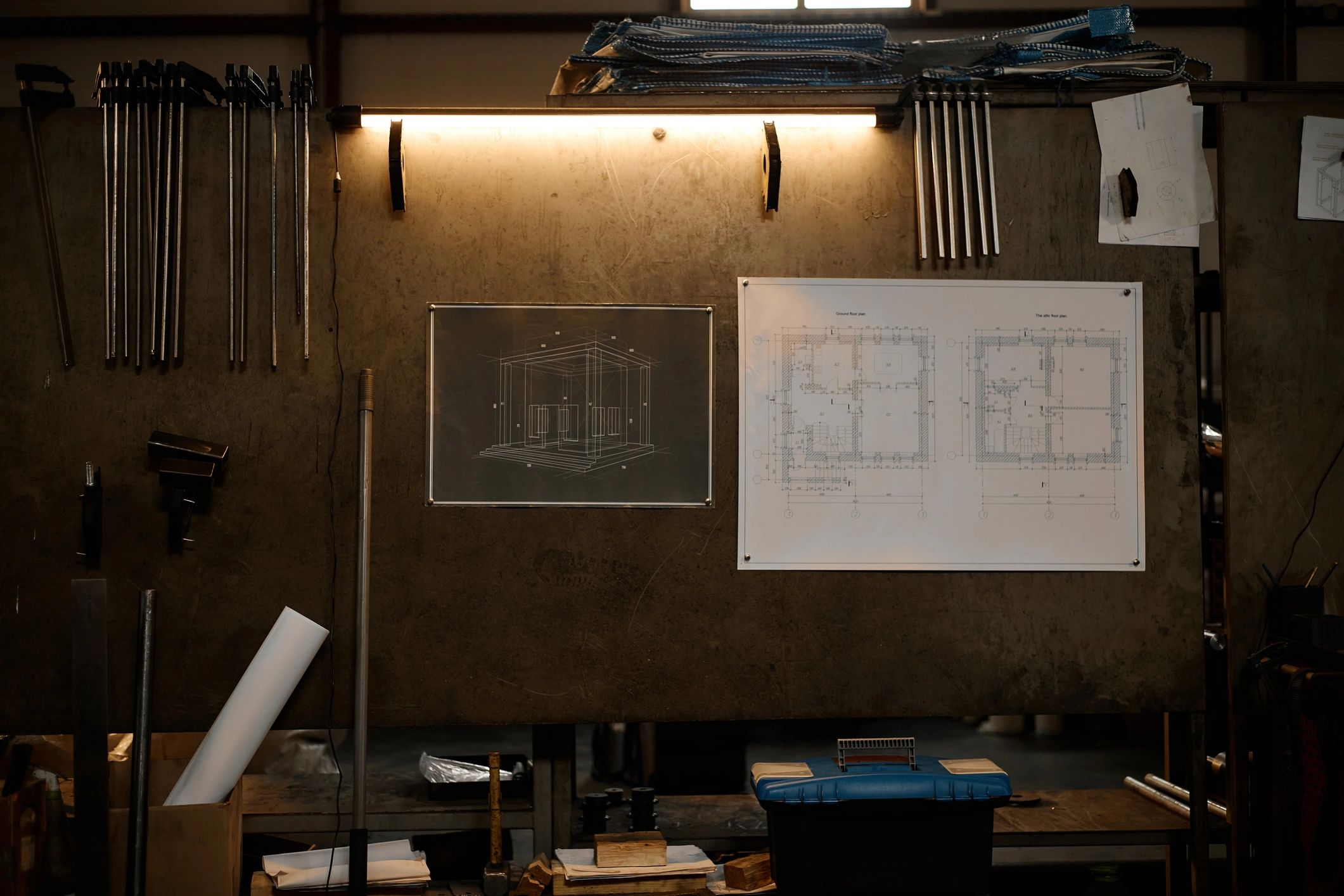 Engineering blueprints displayed in a workshop setting