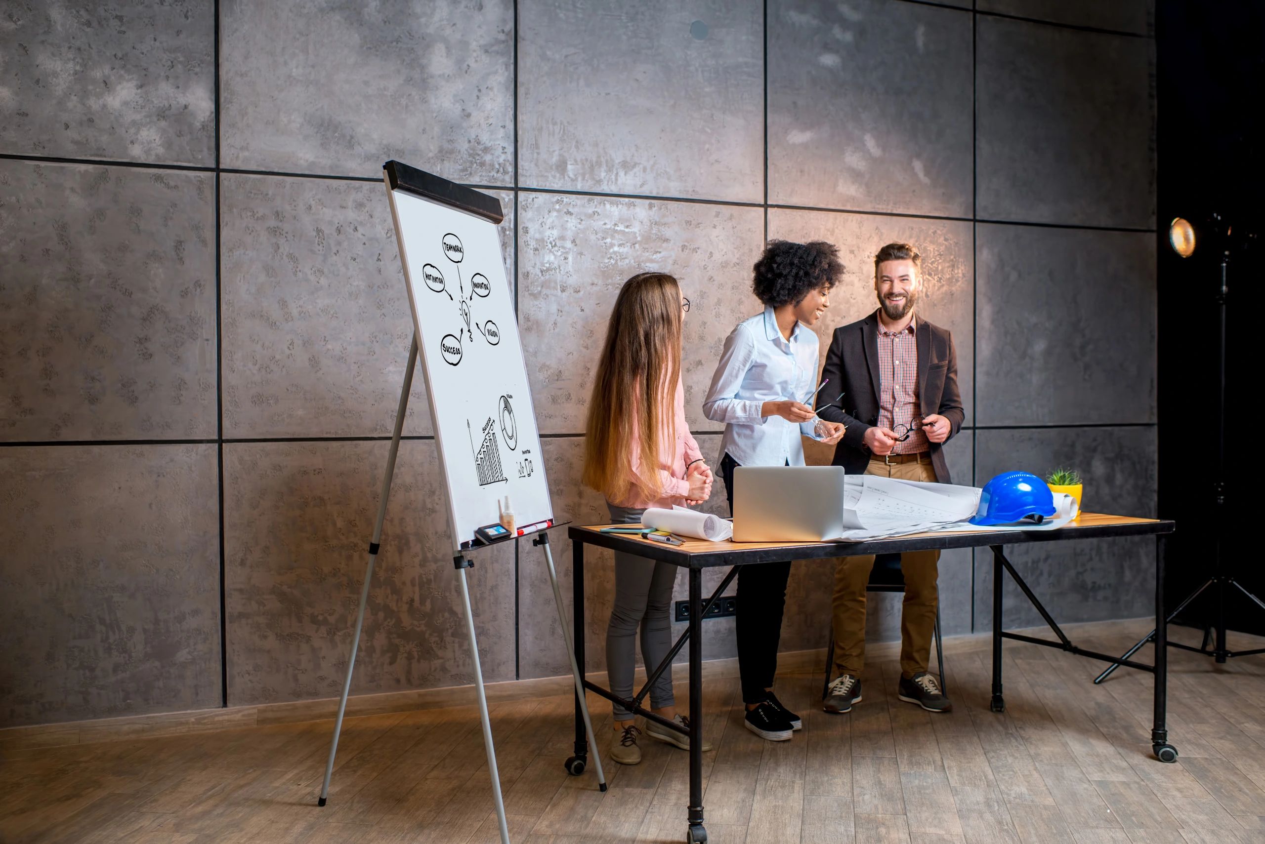 Architects working together on plans in a modern office